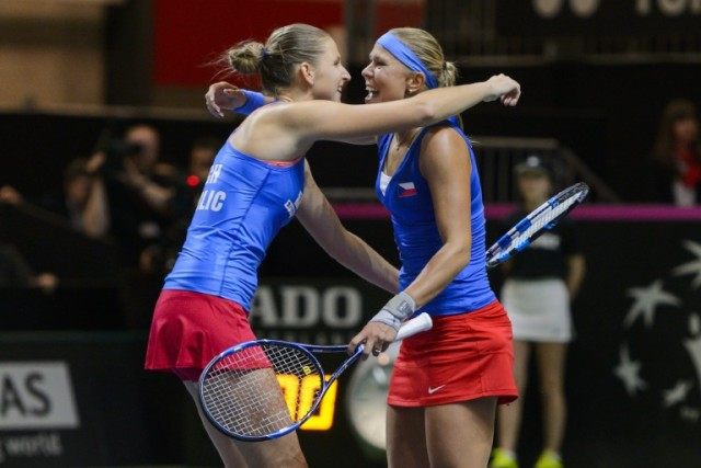 Czech tennis players Karolina Pliskova (L) and Lucie Hradeck celebrate after defeating Swi
