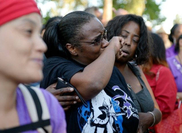 Fans mourn the loss of a music legend at a candlelight vigil in Los Angeles on April 21, 2