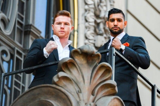 Canelo Alvarez (L) and Amir Khan (R) pose for photos during a press event on March 1, 2016