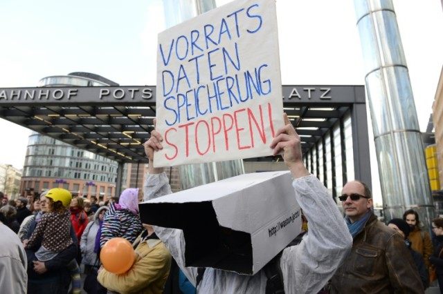 A demonstrator holds up a poster reading, "Stop data preservation" during a protest in Ber