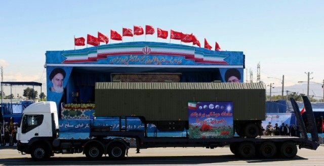 An Iranian military truck carries parts of the S-300 missile system during the Army Day pa