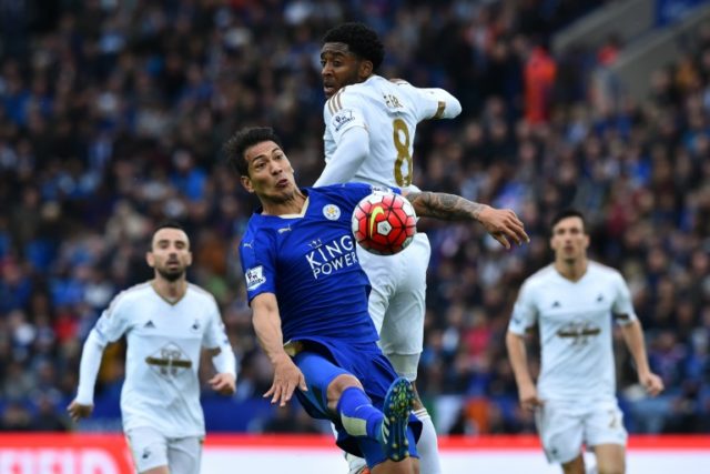 Leicester City's striker Leonardo Ulloa (CL) tries to win the ball against Swansea City's