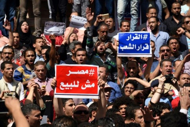 Egyptian protesters with placards shout slogans during a demonstration against a controver