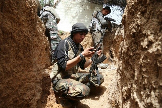 Fighters from the Jaish al-Islam (Islam Army) hold a position in the rebel-held town of Do