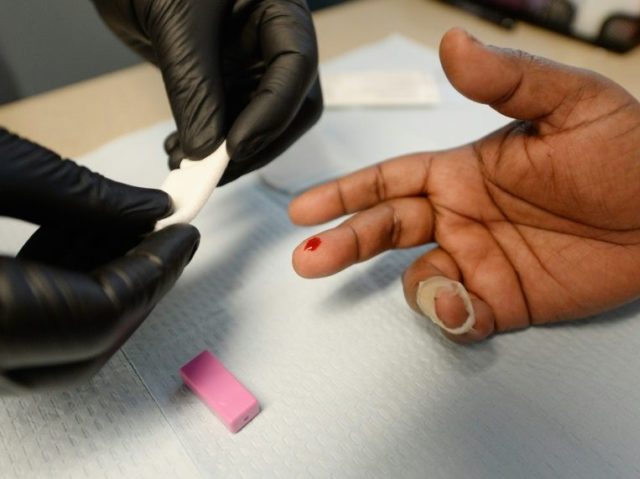 A woman gets an instant HIV/AIDS test