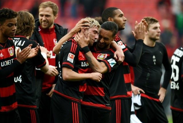 Leverkusen midfielders Kevin Kampl (C-L) and Karim Bellarabi celebrate after the Bundeslig