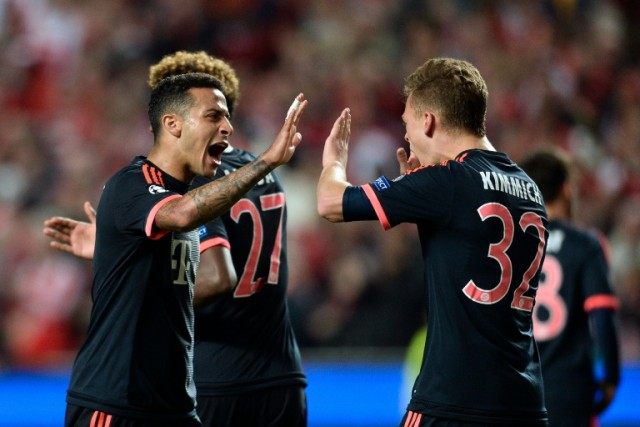 Bayern Munich's Thiago Alcantara (L) celebrates with teammate Joshua Kammich at the end of