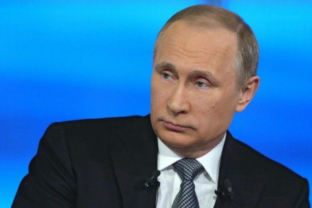 Russian President Vladimir Putin listens to a question during his annual phone-in show in