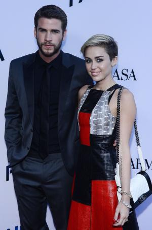 Miley Cyrus and Liam Hemsworth attend 'Huntsman' premiere