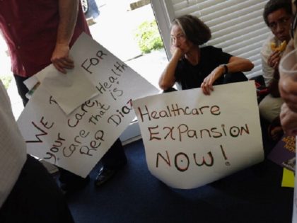 MIAMI, FL - SEPTEMBER 20: Deborah Dion and other protesters gather in the office of Florid