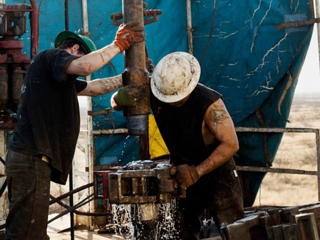 Workers on Big Dog Drilling Rig 22, owned by Endeavor Energy Resources, L.P., on the outsk