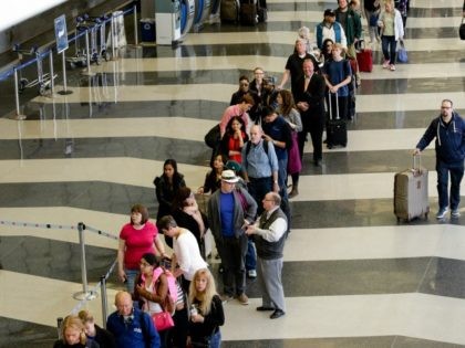A long line of travelers wait for the TSA security check point at O'Hare International airport, Monday, May 16, 2016, in Chicago. Already faced with lines that snake through terminals out to the curb, fliers are bracing for long waits at security in the busy months of July and August. …