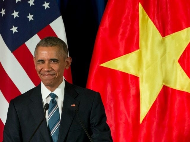 Barack Obama winks as he arrives for a news conference with Vietnamese President Tran Dai