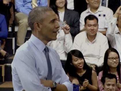 In this image made from pool video, U.S. President Barack Obama listens as Vietnamese rapp