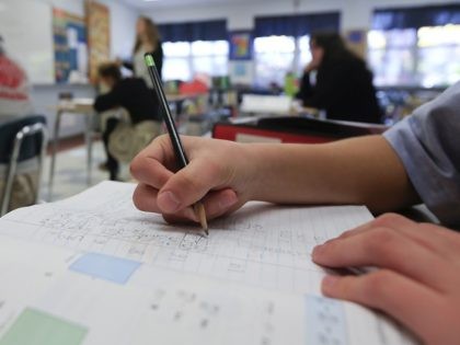 In this Tuesday, Nov. 17, 2015 photo, a student works in an eight grade algebra class at Holy Spirit School in East Greenbush, N.Y. The Diocese of Albany, New York, announced recently that it will reduce the frequency of the Common Core-aligned tests while sticking with the standards. The decision …