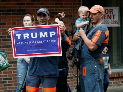 Coal miner Chris Steele holds a sign supporting Donald Trump outside a Democratic presidential candidate Hillary Clinton event in Williamson, W.V., Monday, May 2, 2016.