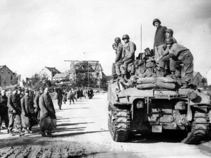 American troops on a tank, heading into the city of Aachen, Germany, on Oct. 15, 1944, as