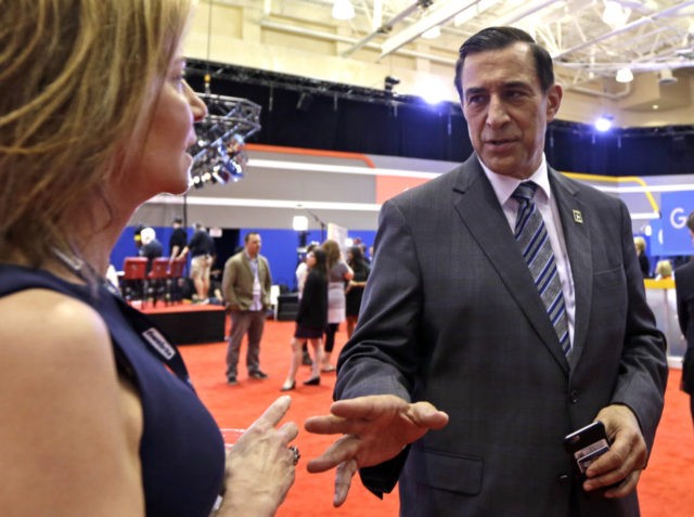 Rep. Darrell Issa, R-Calif., talks to a reporter in the media filing room before the Republican presidential debate sponsored by CNN, Salem Media Group and the Washington Times at the University of Miami, Thursday, March 10, 2016, in Coral Gables, Fla. (AP Photo/Alan Diaz)