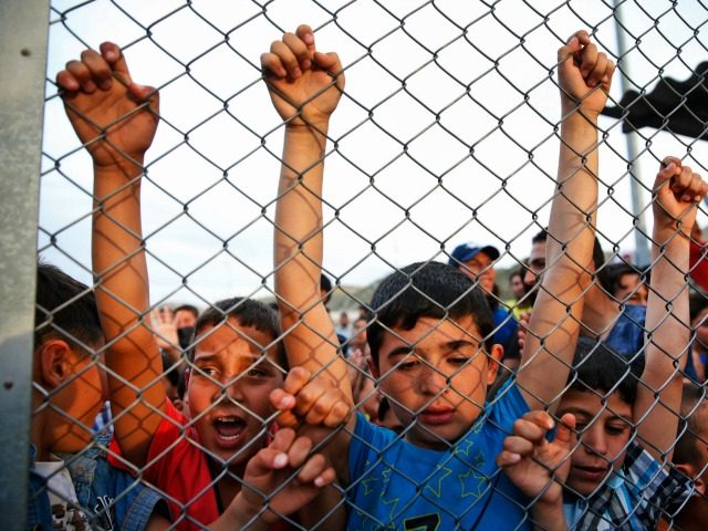 Syrian refugee children behind a fence at the Nizip refugee camp in Gaziantep province, so