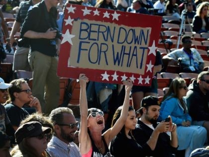 A supporter holds a sign as US Democratic presidential hopeful Bernie Sanders speaks at an election rally in Irvine, California on May 22, 2016. / AFP / Mark Ralston (Photo credit should read MARK RALSTON/AFP/Getty Images)
