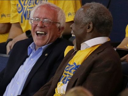 Democratic presidential candidate Sen. Bernie Sanders, I-Vt., left, laughs with actor Danny Glover during Game 7 of the NBA basketball Western Conference finals between the Golden State Warriors and the Oklahoma City Thunder in Oakland, Calif., Monday, May 30, 2016.