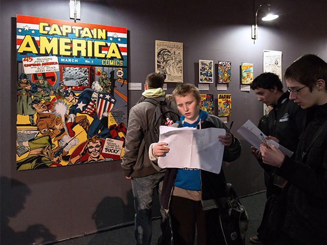 A copy of the March 1941 first cover of US comic 'Captain America' by US artist Jack Kirby is displayed (L) as youths attend the 42nd Angouleme International Comics Festival (Festival international de la bande dessinee d'Angouleme) on Friday 30, 2015 in Angouleme, central France.