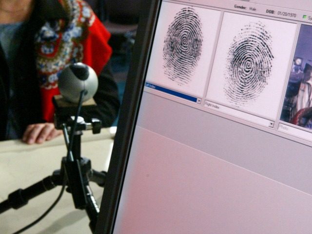 Penelope Smith, of the US-VISIT Program, demonstrates the process of inkless fingerprints