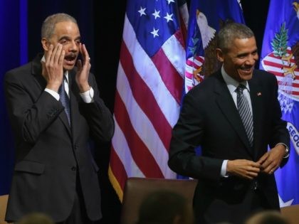 US President Barack Obama (R) and U.S. Attorney General Eric Holder react at the introduct