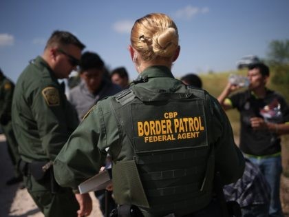 MCALLEN, TX - AUGUST 07: U.S. Border Patrol agents detain undocumented immigrants after they crossed the border from Mexico into the United States on August 7, 2015 in McAllen, Texas. The state's Rio Grande Valley corridor is the busiest illegal border crossing into the United States. Border security and immigration …