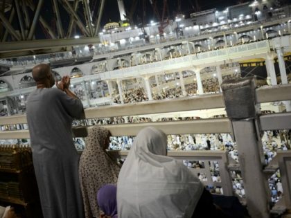 Muslim pilgrims pray near the Islam's holiest shrine, the Kaaba, …