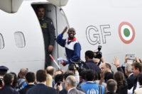 An Eritrean refugee blows a kiss to say goodbye as he boards a plane to travel to Sweden as part of a new programme of the European Union to relocate refugees on October 9, 2015 at the Ciampino airport of Rome. A small group of Eritreans left Italy for Sweden, …