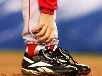 Curt Schilling #38 of the Boston Red Sox grabs at his ankle as it appears to be bleeding in the fourth inning during game six of the American League Championship Series against the New York Yankees on October 19, 2004 at Yankee Stadium in the Bronx borough of New York …
