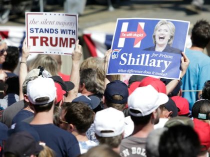 A supporter holds a sign mocking Democratic presidential candidate Hillary Clinton during