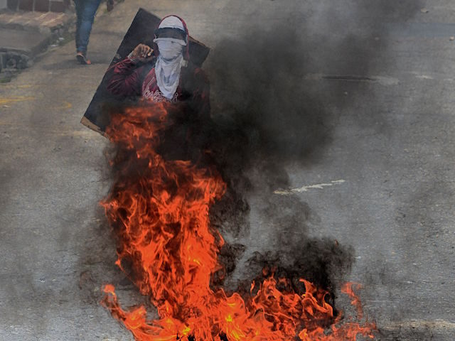 Venezuelan opposition activists clash with the police during a demonstration in San Cristo