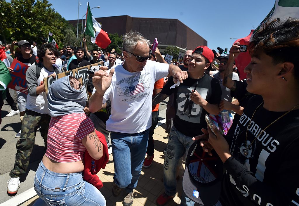 Protesters surround and taunt a man as he leaves a rally where republican presidential candidate Donald Trump spoke in Fresno, California on May 27, 2016. / AFP / JOSH EDELSON (Photo credit should read JOSH EDELSON/AFP/Getty Images)