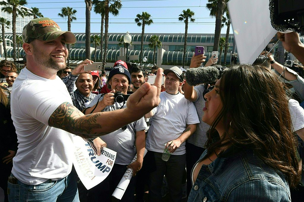 Protesters and supporters of Republican presidential candidate Donald Trump argue during a rally outside Trump's event in San Diego, California, on May 27, 2016. / AFP / Mark Ralston (Photo credit should read MARK RALSTON/AFP/Getty Images)