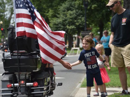 A child greets motorcyclists during the annual Rolling Thunder "Ride for Freedom&quot