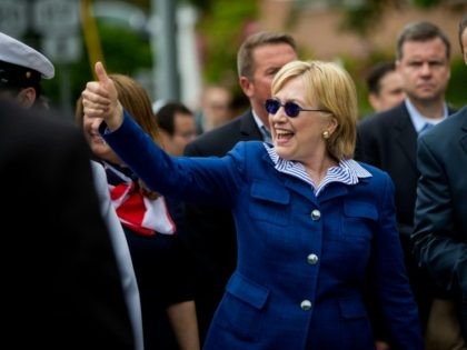 Democratic presidential candidate former Secretary of State Hillary Clinton and New York Governor Andrew M. Cuomo walk in the Memorial Day parade May 30, 2016 in Chappaqua, New York. (Photo by