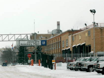 A worker walks to his vehicle after their final production line duties at the Janesville G