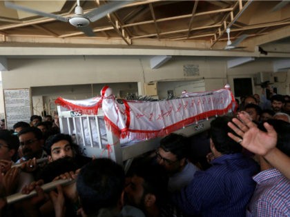 Relatives carry the coffin of Khurram Zaki who was shot by gunmen, during his funeral in K
