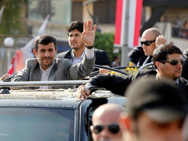 Iranian President Mahmoud Ahmadinejad waves to the crowed in southern suberb of Beirut upo