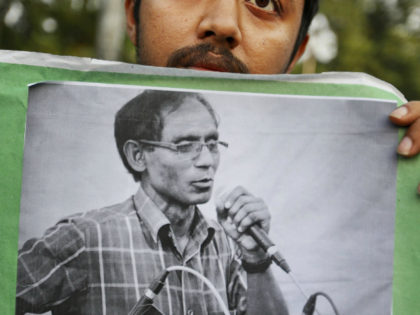 FILE- In this April 29, 2016 file photo, a Bangladeshi student holds a portrait of a Unive