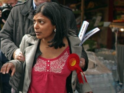 abour prospective parliamentary candidate for Ealing Central and Acton constituency Rupa Huq (R) is grabbed from behind by Karim Sacoor, a campaign volunteer for Conservative parliamentary candidate Angie Bray, as she tries to debate with London Mayor Boris Johnson as he met with voters on May 1, 2015 in London, …