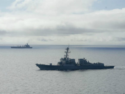 The USS William P. Lawrence guided missile destroyer, below, awaits refueling from a tanke