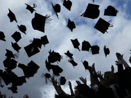 Students throw their mortarboards in the air during their graduation photograph at the University of Birmingham degree congregations on July 14, 2009 in Birmingham, England.