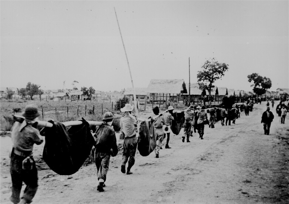 "This picture, captured from the Japanese, shows American prisoners using improvised litters to carry those of their comrades who, from the lack of food or water on the march from Bataan, fell along the road." Philippines, May 1942. (Wikimedia Commons)