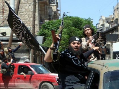 Fighters from Al-Qaeda's Syrian affiliate Al-Nusra Front drive in the northern Syrian city of Aleppo flying Islamist flags as they head to a frontline, on May 26, 2015.