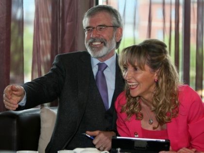 Sinn Fein President Gerry Adams (L) shares a joke with Sinn Fein European election candidate and member of the European Parliament, Martina Anderson (R), during their European Election manifesto launch in Belfast, Northern Ireland on May 12, 2014.