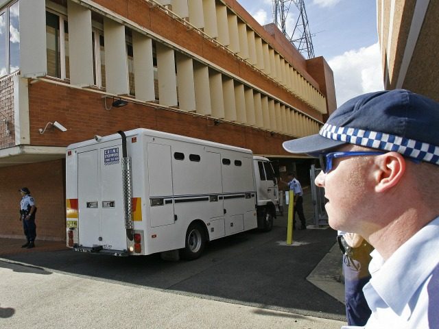 Sydney, AUSTRALIA: Police form a security cordon as a prison van carrying nine Muslim men