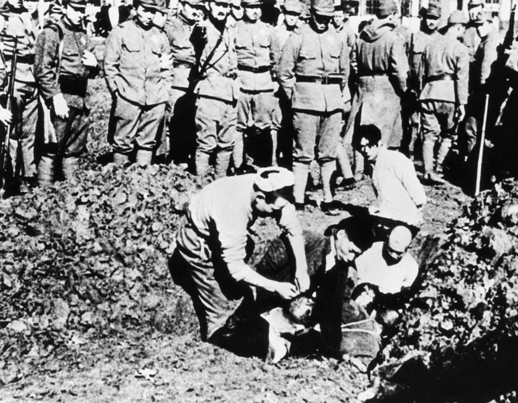 Chinese prisoners being buried alive by their Japanese captors outside the city of Nanking, November 1938